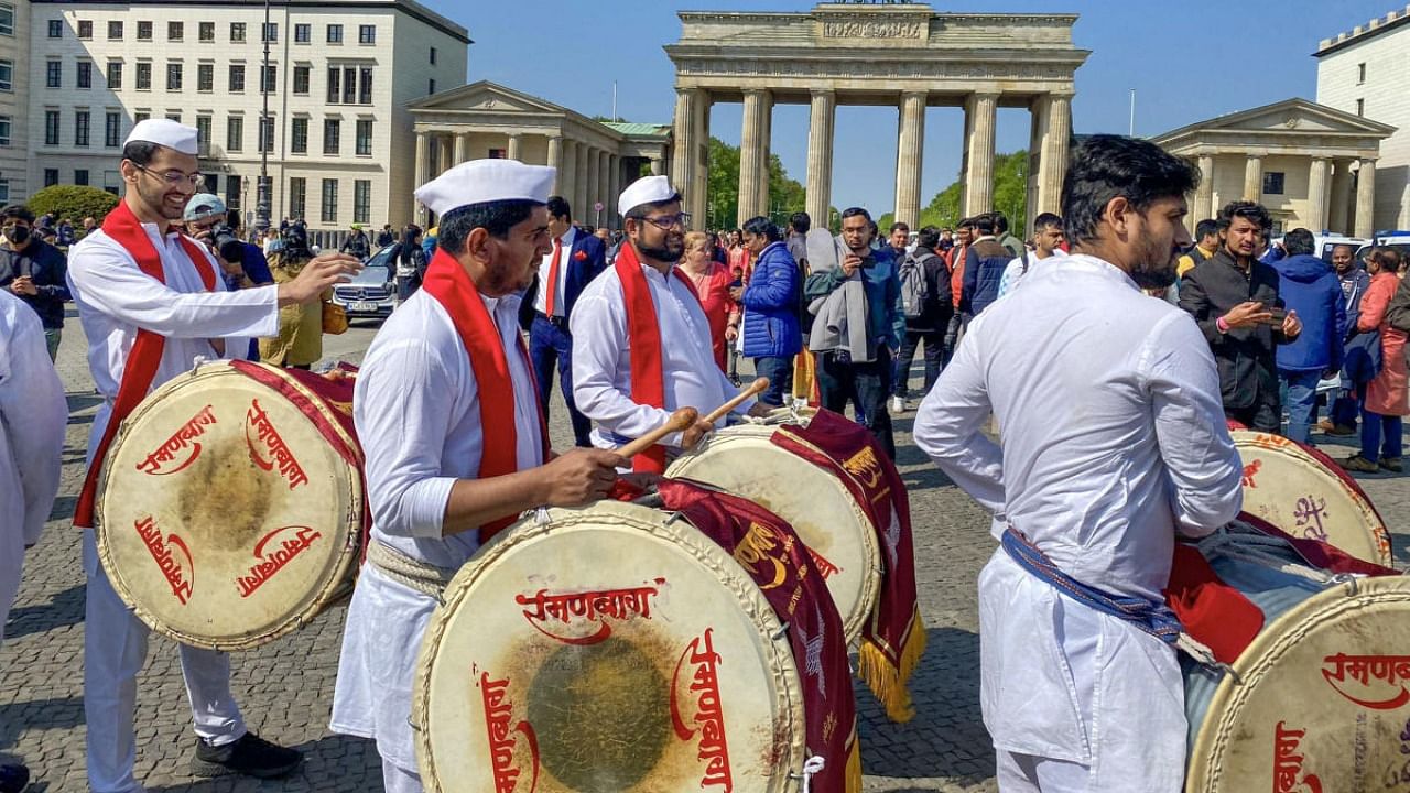 People from the Indian community gather at Brandenburg Gate to welcome Prime Minister Narendra Modi, in Berlin. Credit: PTI file photo