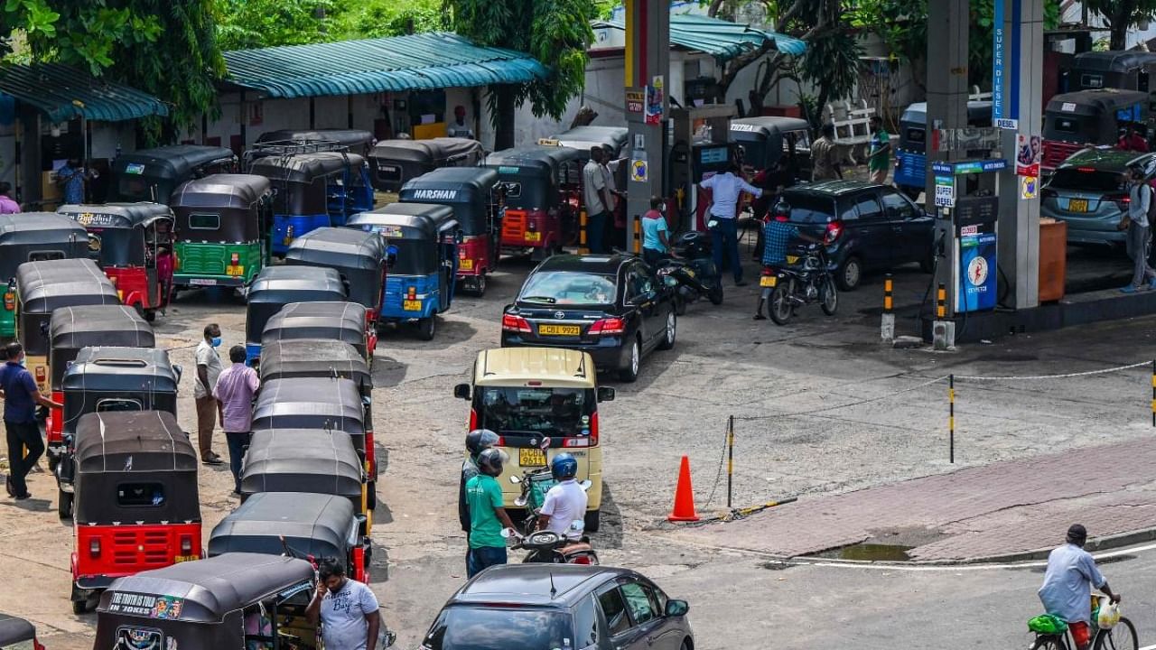 Motorists queue up to buy fuel at a Ceylon Petroleum Corporation fuel station in Colombo. Credit: AFP Photo