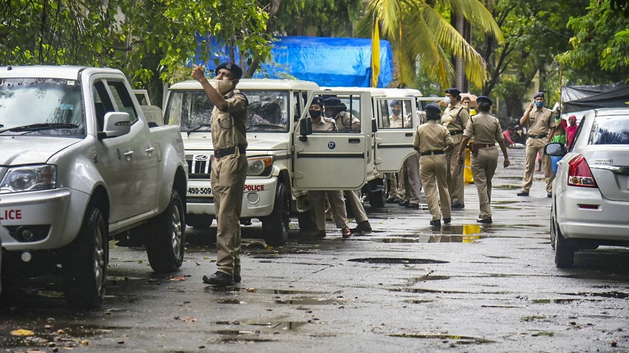 A team of NIA arrives to conduct a raid at former 'encounter specialist' police officer Pradeep Sharma’s residence at Andheri, in connection with the 'Antilia’ bomb scare case and businessman Mansukh Hiren’s murder case. Credit: PTI file photo