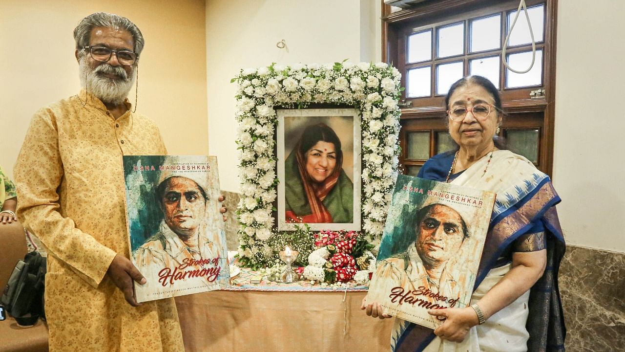  Artist Vasudeo Kamat and singer Usha Mangeshkar during the press conference to announce the launch of the book 'Strokes of Harmony'. Credit: PTI Photo