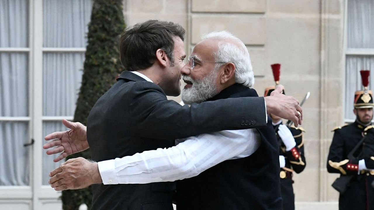 France's President Emmanuel Macron (L) welcomes India's Prime Minister Narendra Modi (R) for a meeting at the Elysee Palace in Paris. Credit: AFP Photo