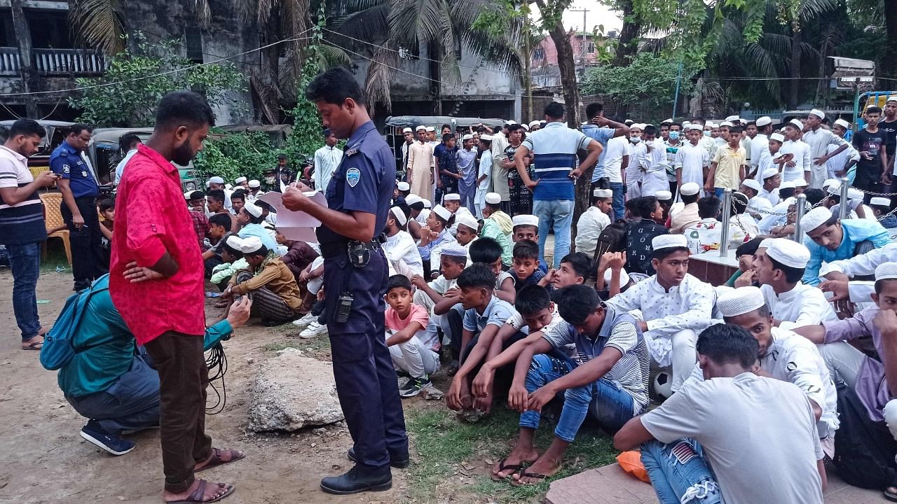 A policeman takes the details of Rohingya refugees who were detained from a beach, at the Sadar Model police station in Cox's Bazar. Credit: AFP Photo