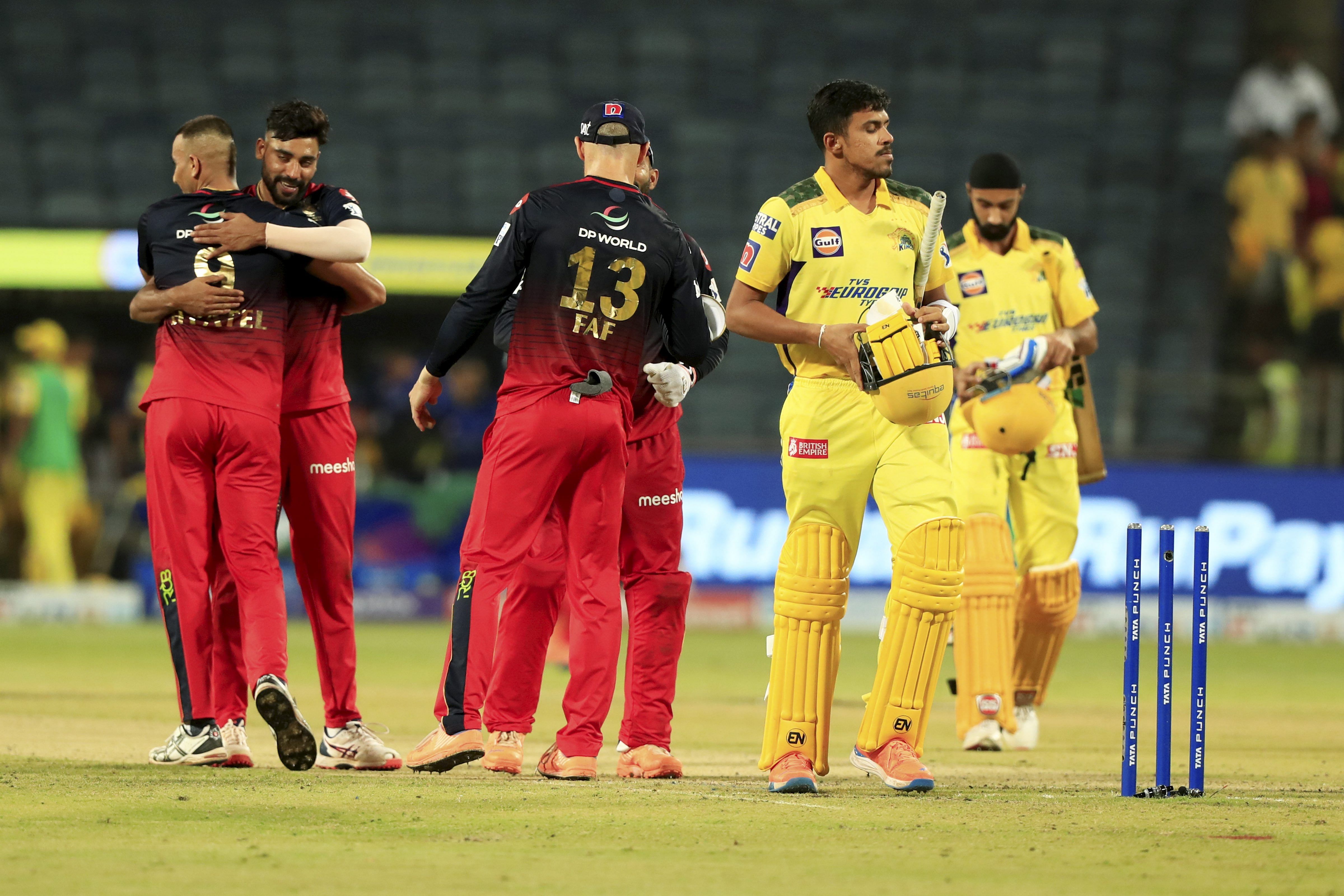 Royal Challengers Bangalore players greet each other celebrating their win against the Chennai Super Kings during the 49th T20 cricket match of the Indian Premier League 2022. Credit: PTI Photo