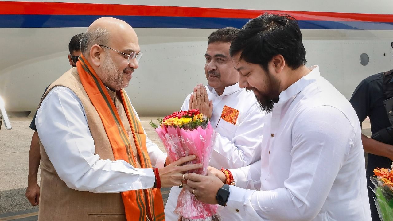 Union Home Minister and senior BJP leader Amit Shah being received by MoS Nitish Pramanik on his arrival, in Kolkata. Credit: PTI Photo