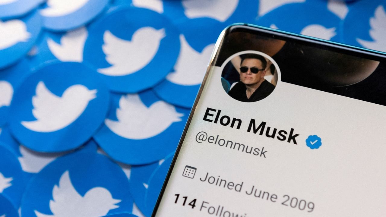Elon Musk's Twitter profile is seen on a smartphone placed on printed Twitter logos. Credit: Reuters File Photo