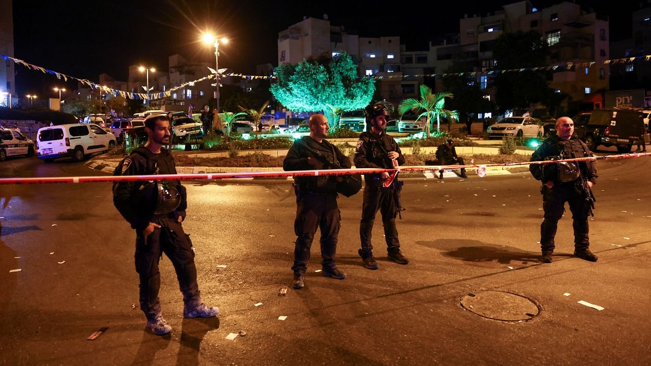 Israeli security personnel guard the area where at least three people were killed in what police suspect was a Palestinian attack in Elad. Credit: Reuters Photo
