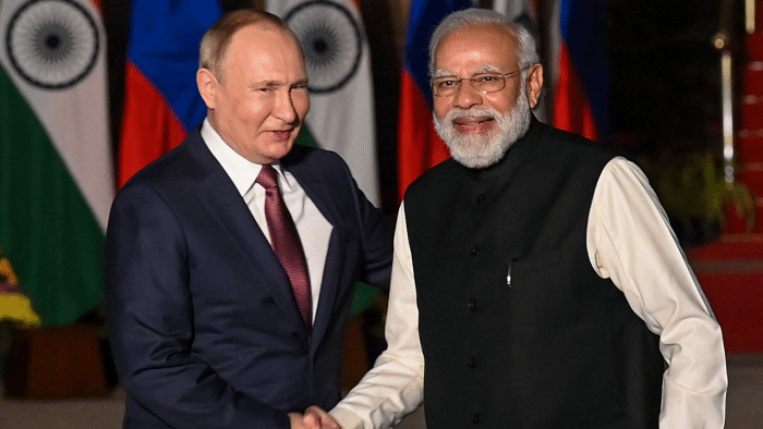 Narendra Modi (R) greets Russian President Vladimir Putin. Credit: AFP Photo