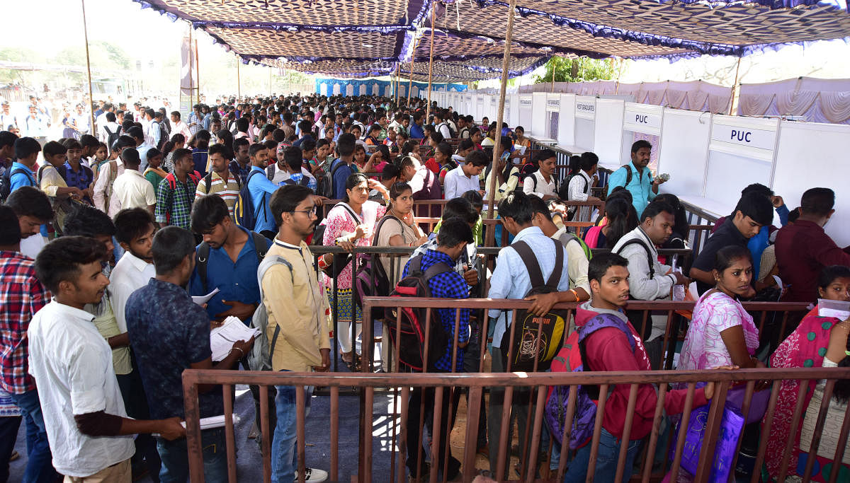 Job aspirants gathered during Mass Job Fair, at Maharaja College Grounds in Mysuru.