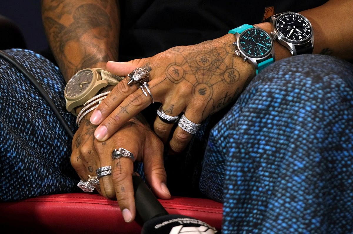 Mercedes' Lewis Hamilton's rings, tattoos and watches are seen during the press conference. Credit: Reuters Photo