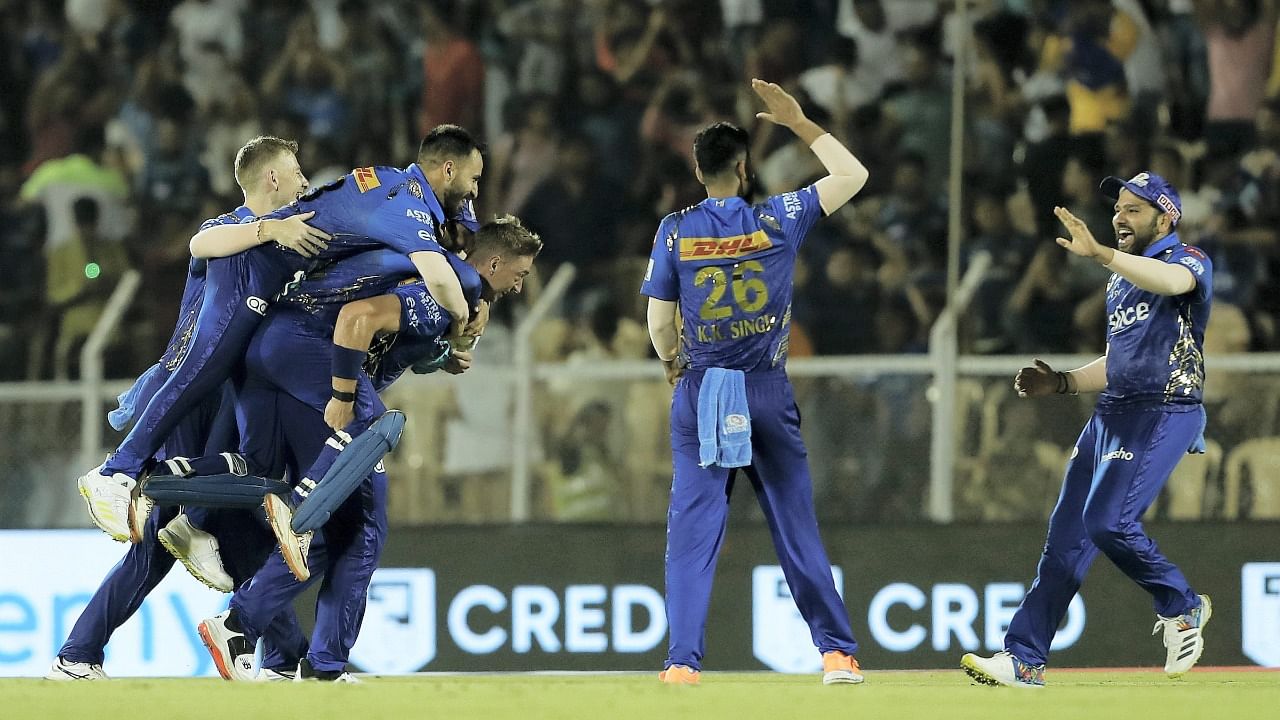 Mumbai Indians players celebrate after winning the 51st T20 cricket match of the Indian Premier League 2022. Credit: PTI Photo