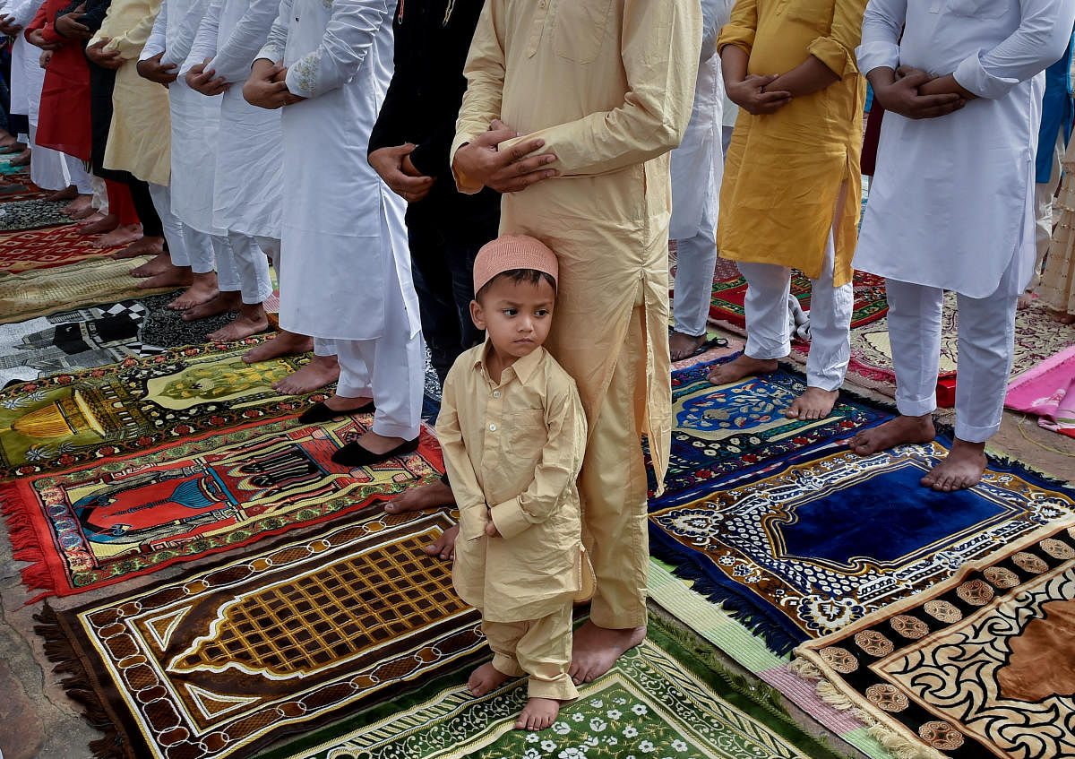 Accepting UCC will come easily if the govt's steps don't seem threatening to minorities. A child offers prayers with adults at a mosque in New Delhi. PTI
