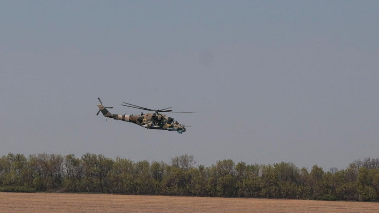 Ukrainian Armed Forces helicopter Mi-24 flies over a field in unknown location in Eastern Ukraine. Credit: Reuters Photo