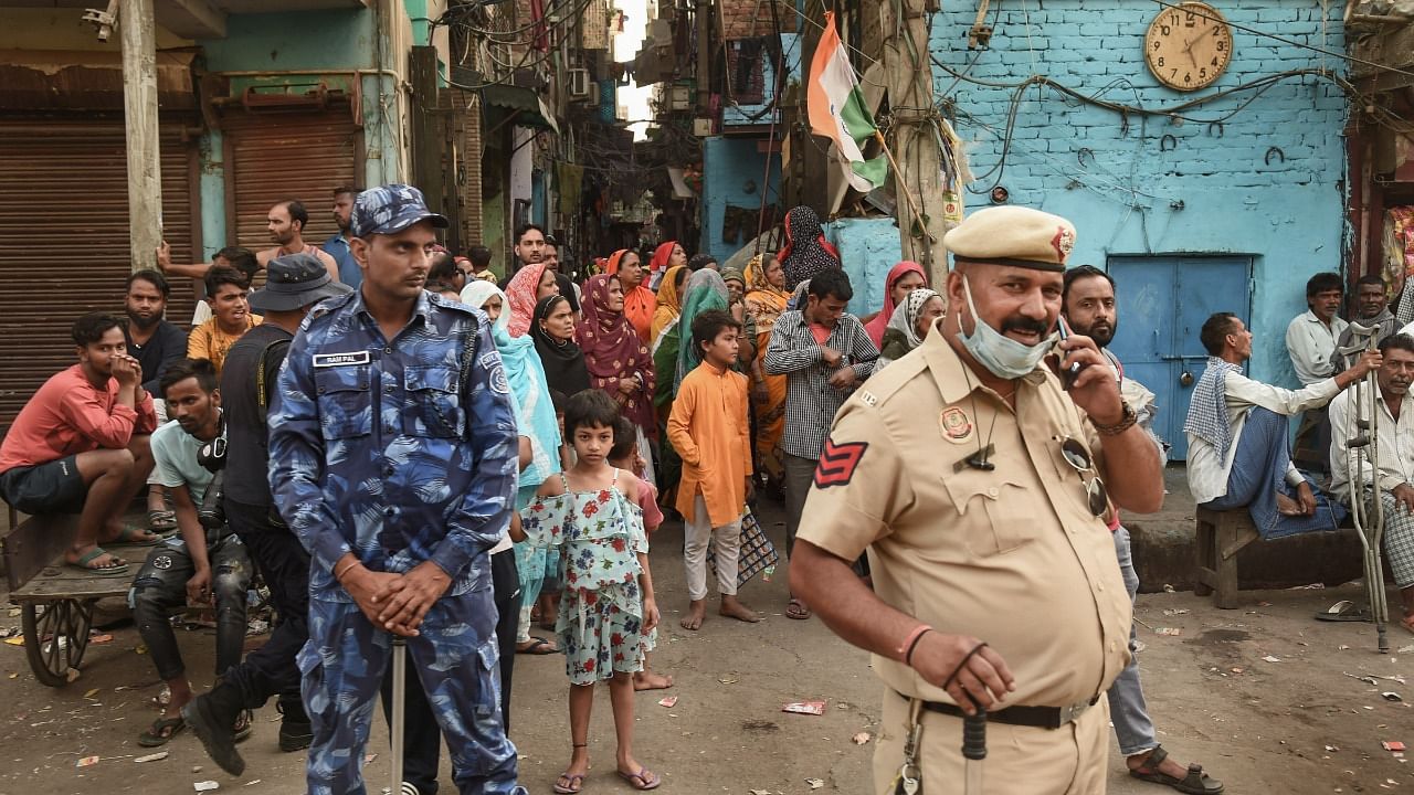 Security personnel during a 'Tiranga Yatra' taken out by members of both Hindu and Muslim communities, at the communal violence-hit Jahangirpuri area. Credit: PTI Photo