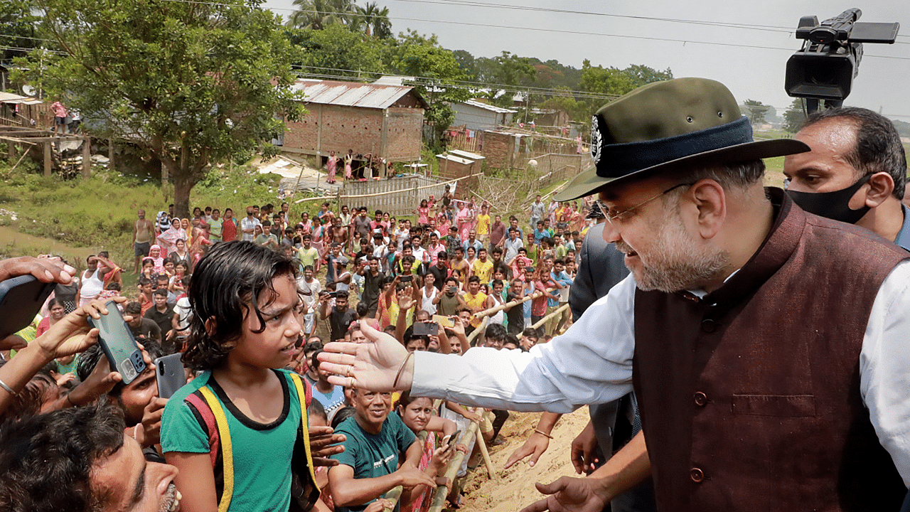 Union Home Minister Amit Shah meets people residing near Mankachar BOP (Border Out-Post) in Assam. Credit: PTI Photo