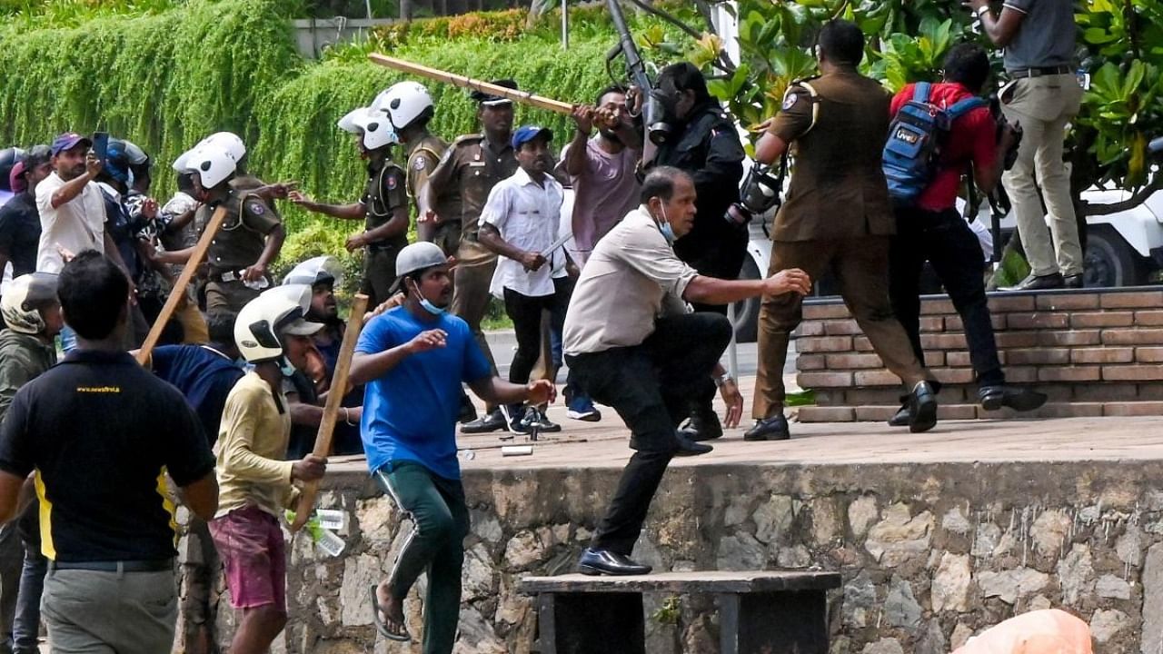 Demonstrators scuffle with the police outside the President's office in Colombo. Credit: AFP Photo