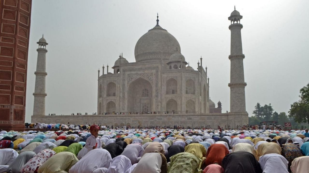 Muslim devotees offer a special morning prayer to start the Eid al-Fitr festival, which marks the end of their holy fasting month of Ramadan, inside the complex of Taj Mahal in Agra. Credit: AFP Photo