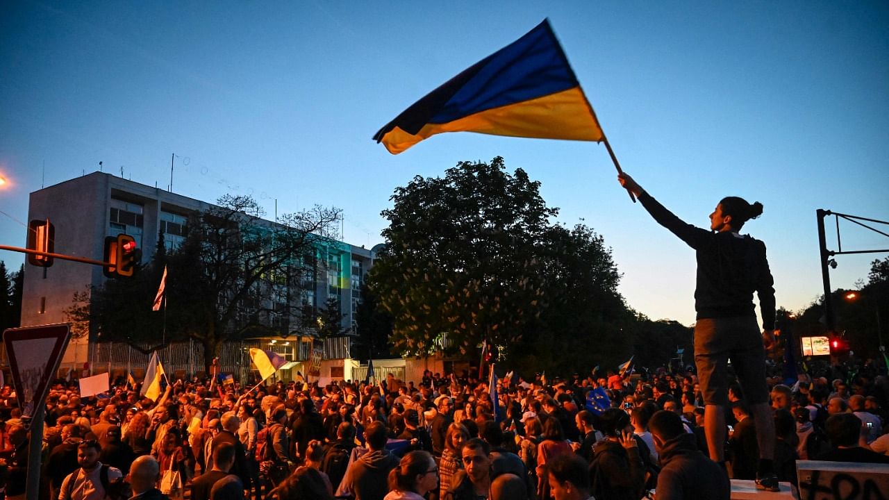 Demonstrator waves Ukrainian flag during a protest against the Russian invasion of Ukraine. Credit: AFP Photo