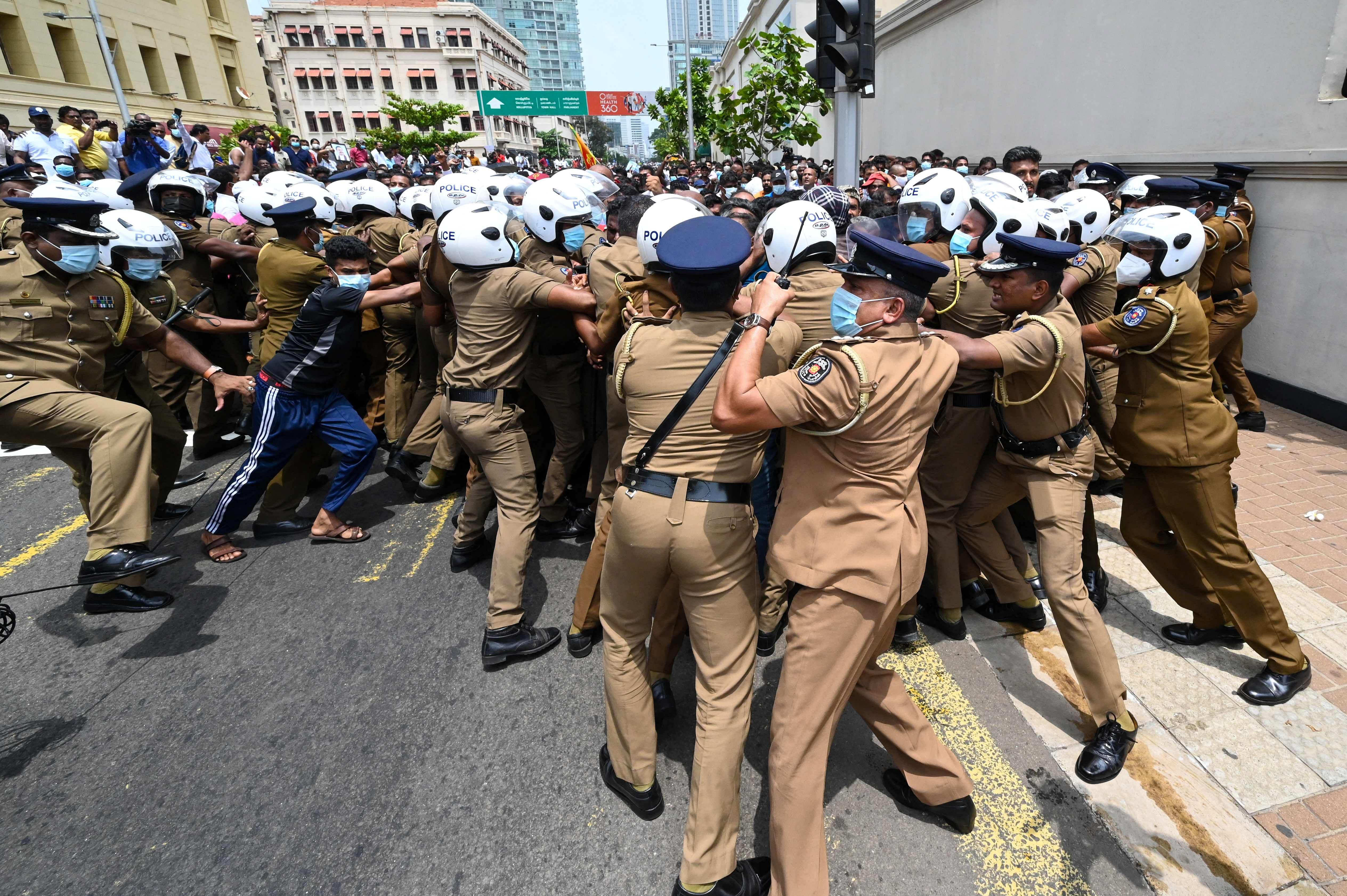 Government supporters and police clash outside the President's office in Colombo. Credit: AFP Photo