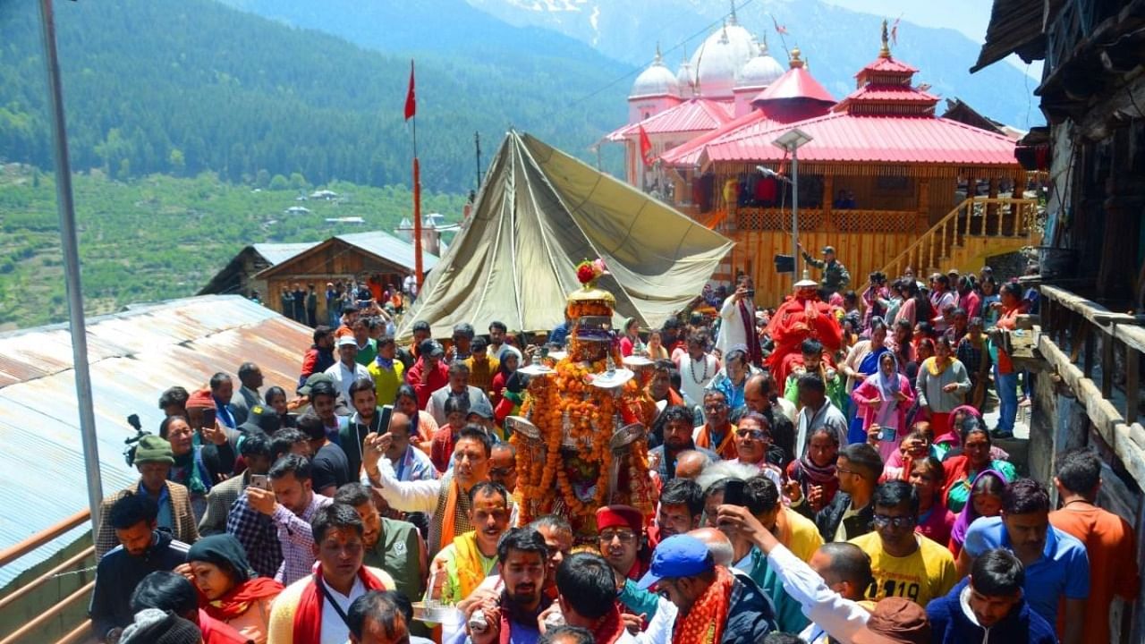 Hindu devotees take out a religious procession with the idol of Goddess Gangotri on the inaugural ceremony of Char Dham Yatra, at Mukhba temple in Uttarkashi on Monday, May 02, 2022. Credit: IANS Photo
