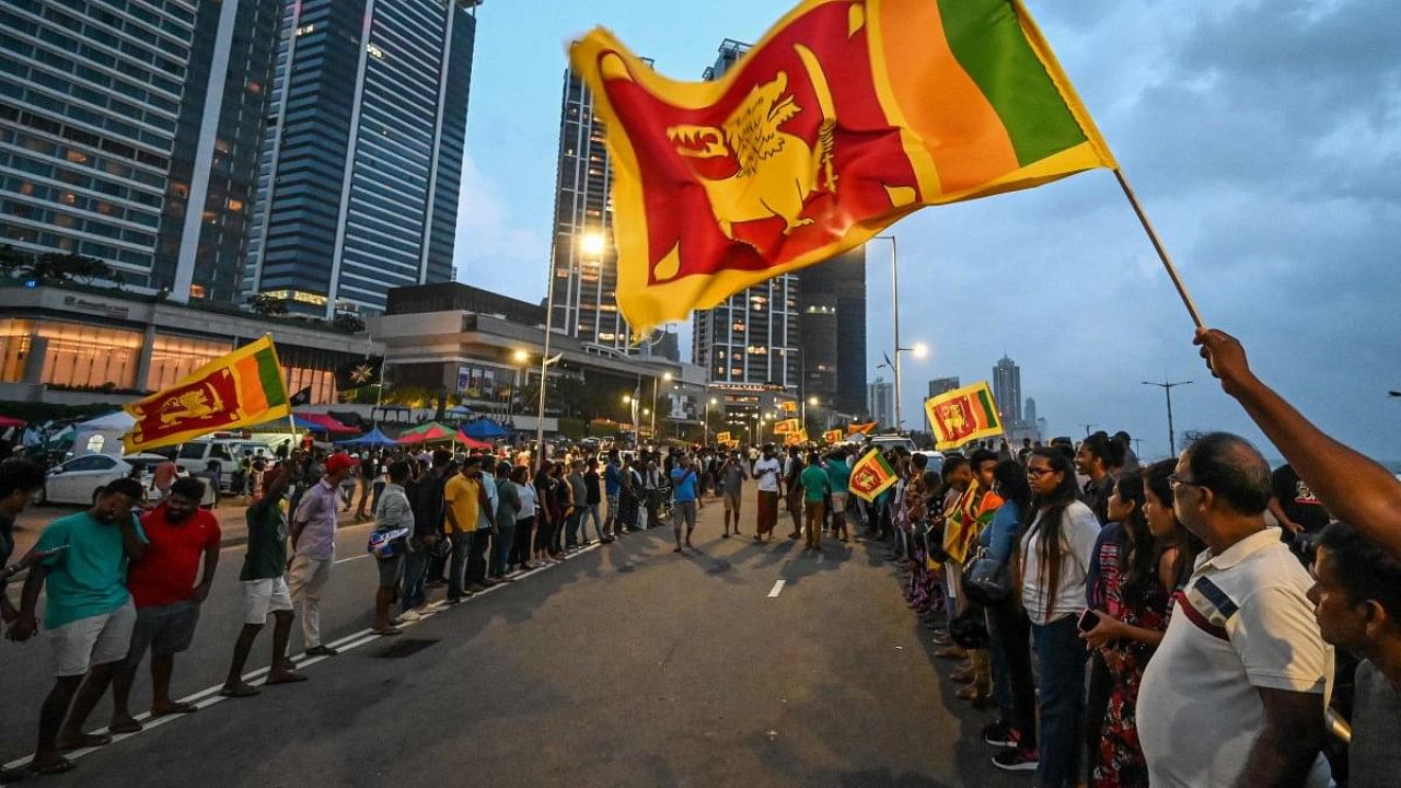 Anti-government demonstrators take part in a protest near the President's office in Colombo. Credit: AFP Photo