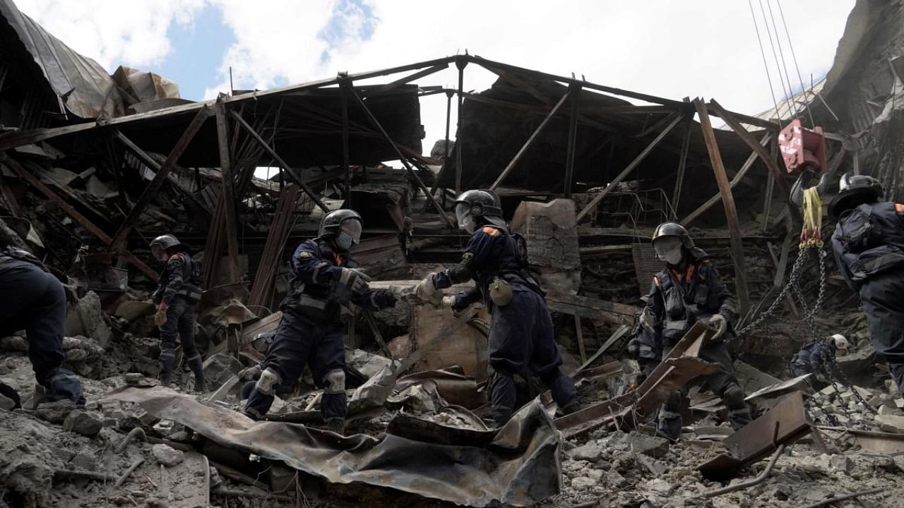 Russian Emergencies personnel clear debris in the partially destroyed Mariupol drama theatre in the city of Mariupol on May 10, 2022, amid the ongoing Russian military action in Ukraine. Credit: AFP Photo