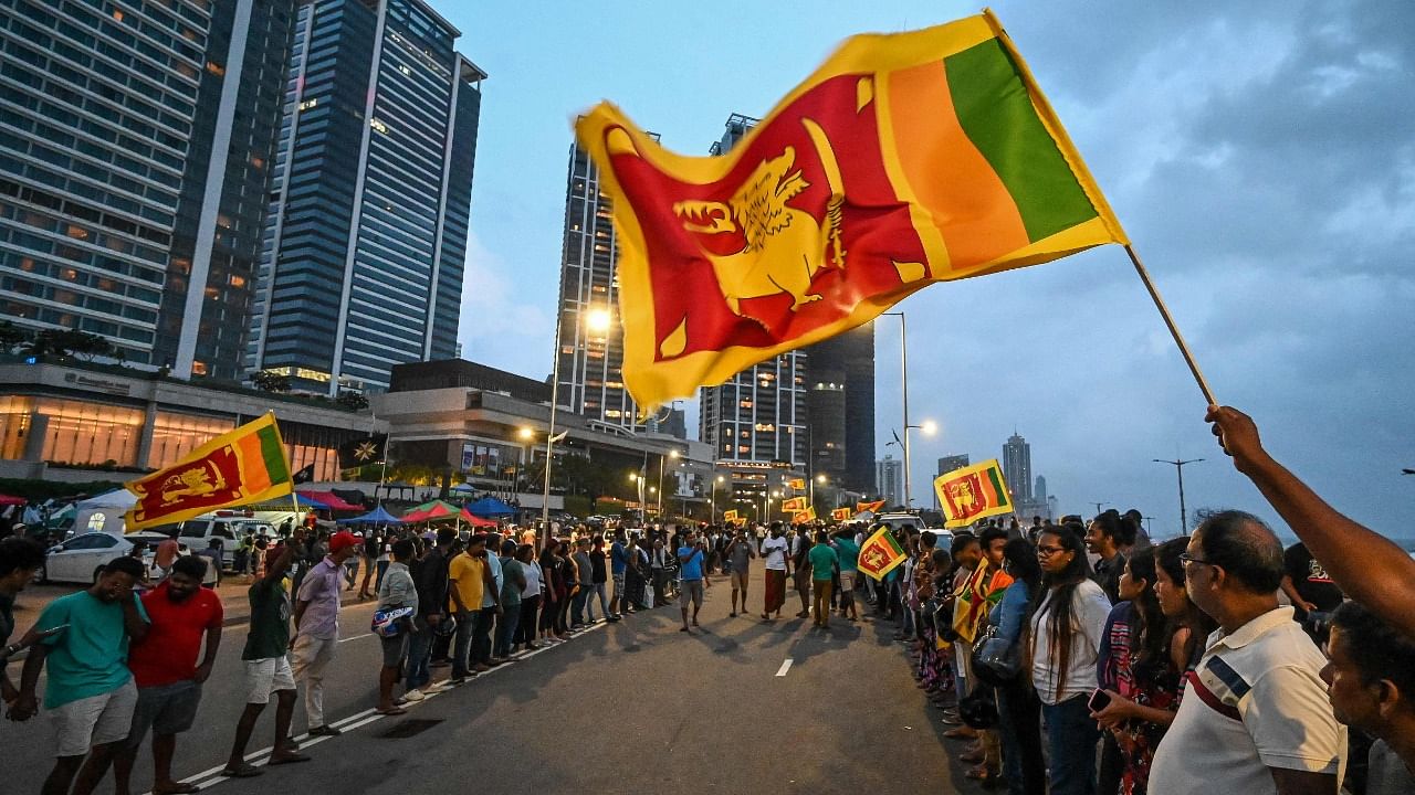 Anti-government demonstrators take part in a protest near the President's office in Colombo. Credit: AFP Photo