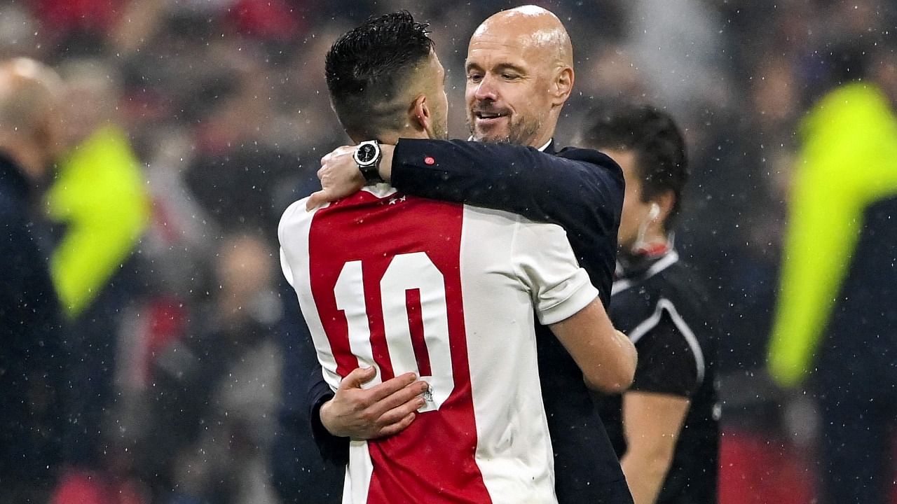 Ajax coach Erik ten Hag (R) and Dusan Tadic of Ajax celebrate after winning the national championship. Credit: AFP Photo