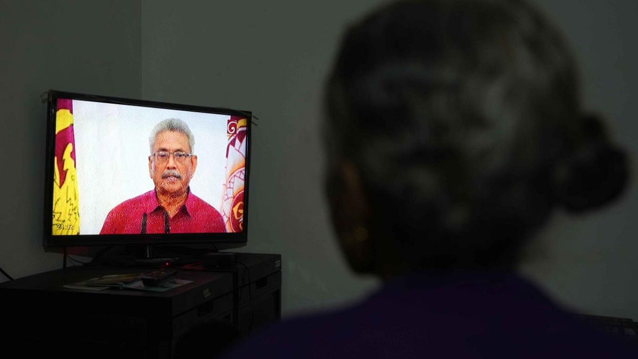 A Sri Lankan woman watches a telecast speech of President Gotabaya Rajapaksa. Credit: AP File Photo