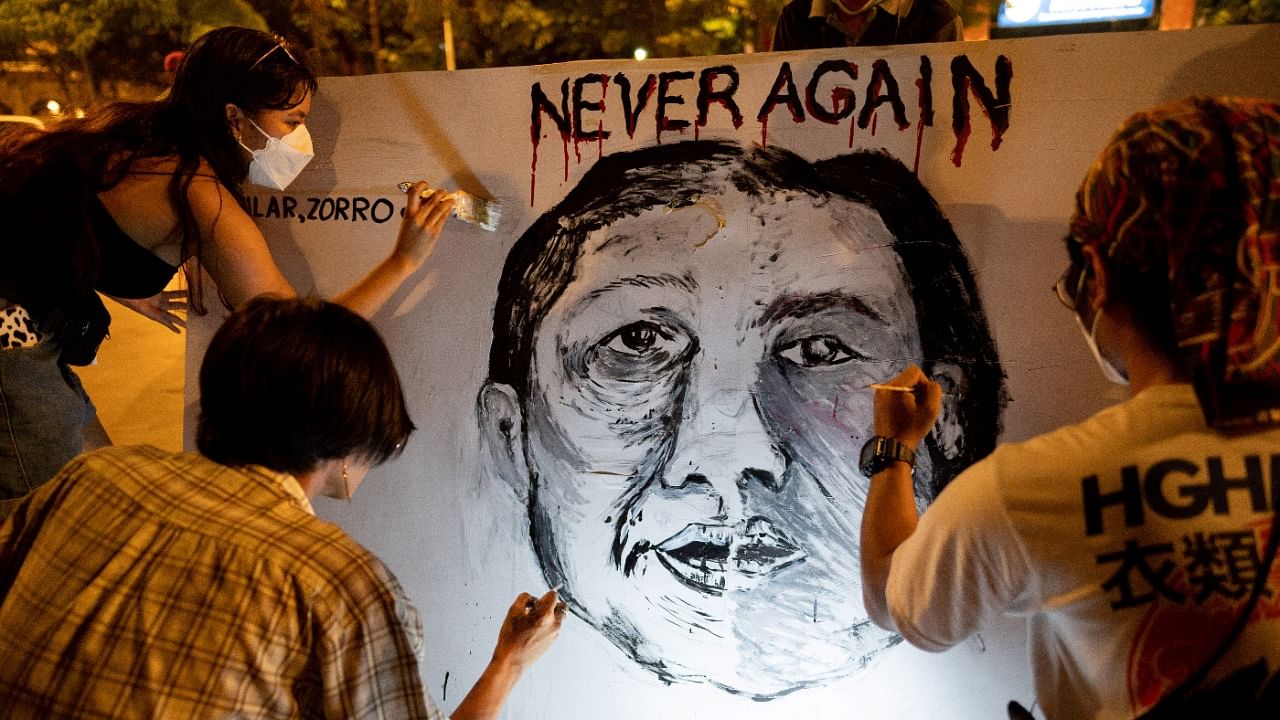 Filipino activists paint a combined images of presidential candidate Ferdinand "Bongbong" Marcos Jr. and vice-presidential candidate Sara Duterte on a poster. Credit: Reuters Photo
