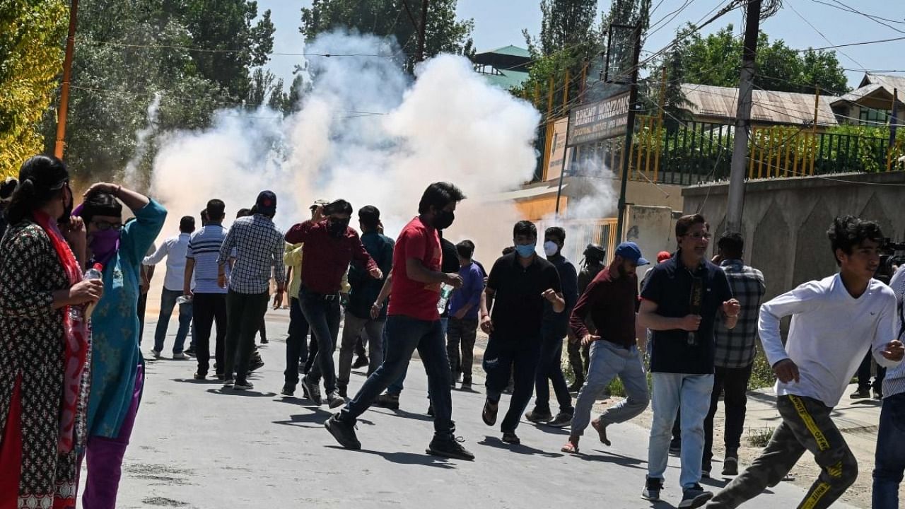 Police fire tear gas to disperse demonstrators marching toward the governor's house to protest against the killing of a government employee belonging to the Kashmiri Pandit community on the outskirts of Srinagar. Credit: AFP Photo