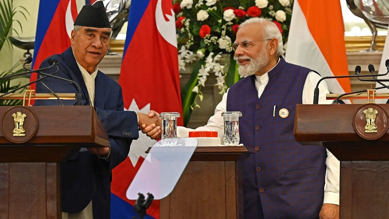 Nepal’s Prime Minister Sher Bahadur Deuba (L) with his Indian counterpart Narendra Modi. Credit: AFP File Photo