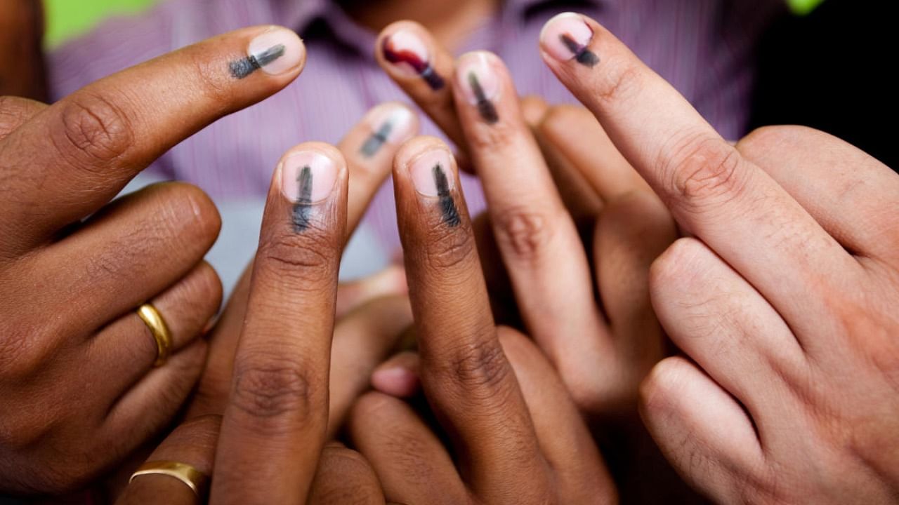 Indian youths showing their mark after voting in the General Elections in India. This mark is an indication that the person has cast it's vote. Credit: PTI Photo