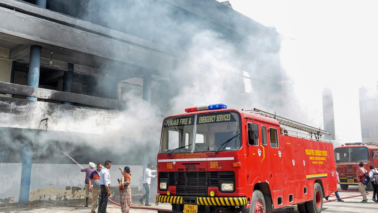 Firefighters try to extinguish the fire that broke out in the Guru Nanak Dev Hospital, in Amritsar. Credit: PTI Photo