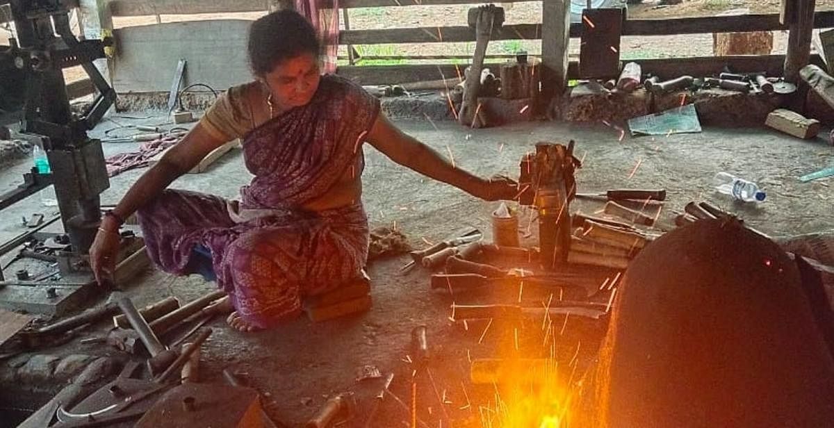 Leelavathi, a blacksmith, busy making iron tools at a workshed in Guthigar Kelagina Pete, in Sullia taluk of Dakshina Kannada district.