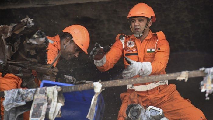 NDRF personnel during rescue and relief operation after a massive fire broke out at an office building near the Mundka Metro Station, in West Delhi. Credit: PTI photo