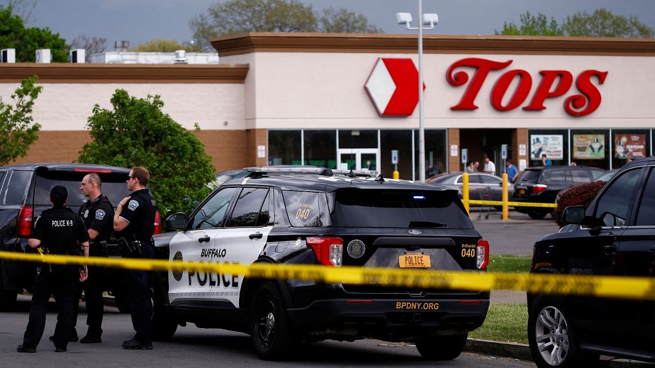 Police officers secure the scene after a shooting at TOPS supermarket in Buffalo. Credit: Reuters Photo