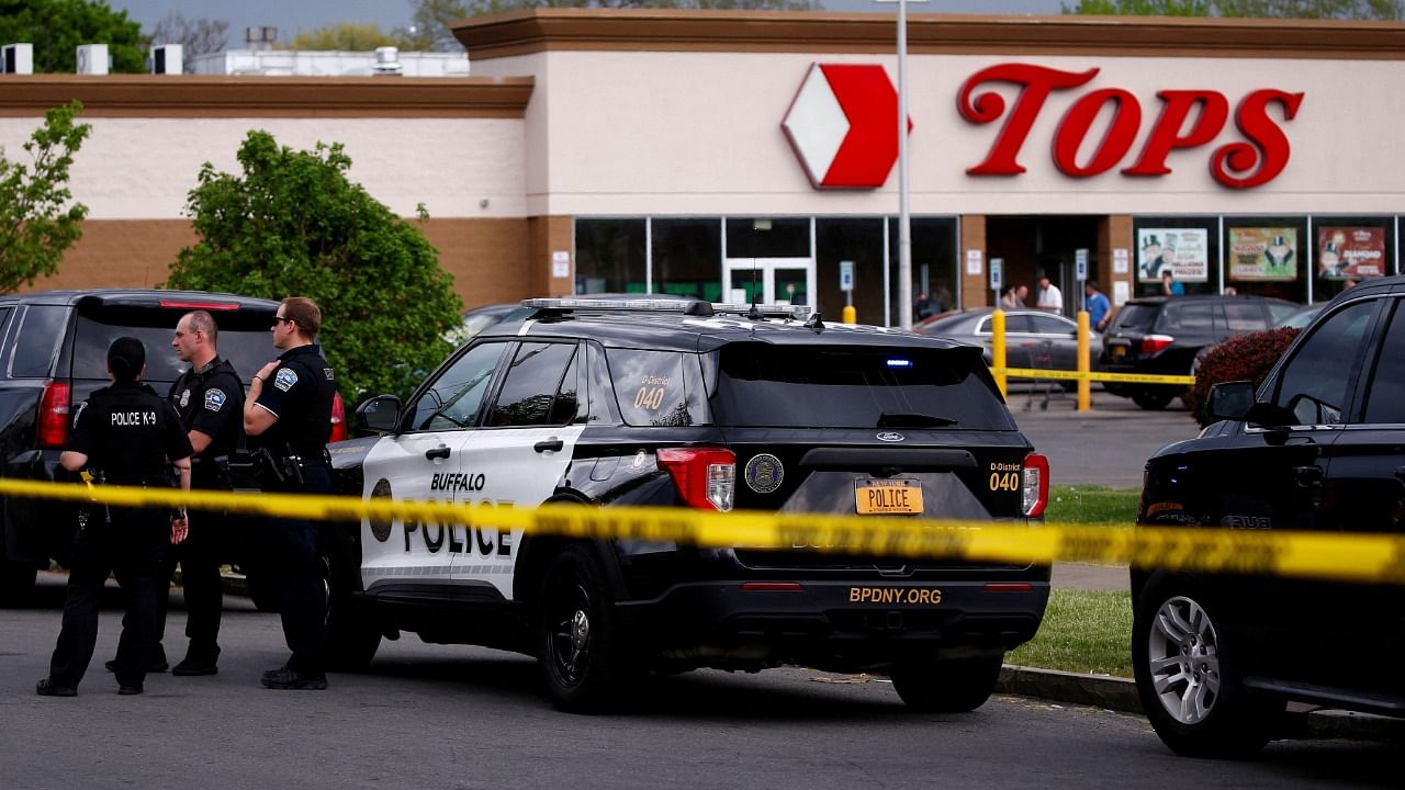 Police officers secure the scene after a shooting at TOPS supermarket in Buffalo. Credit: Reuters Photo
