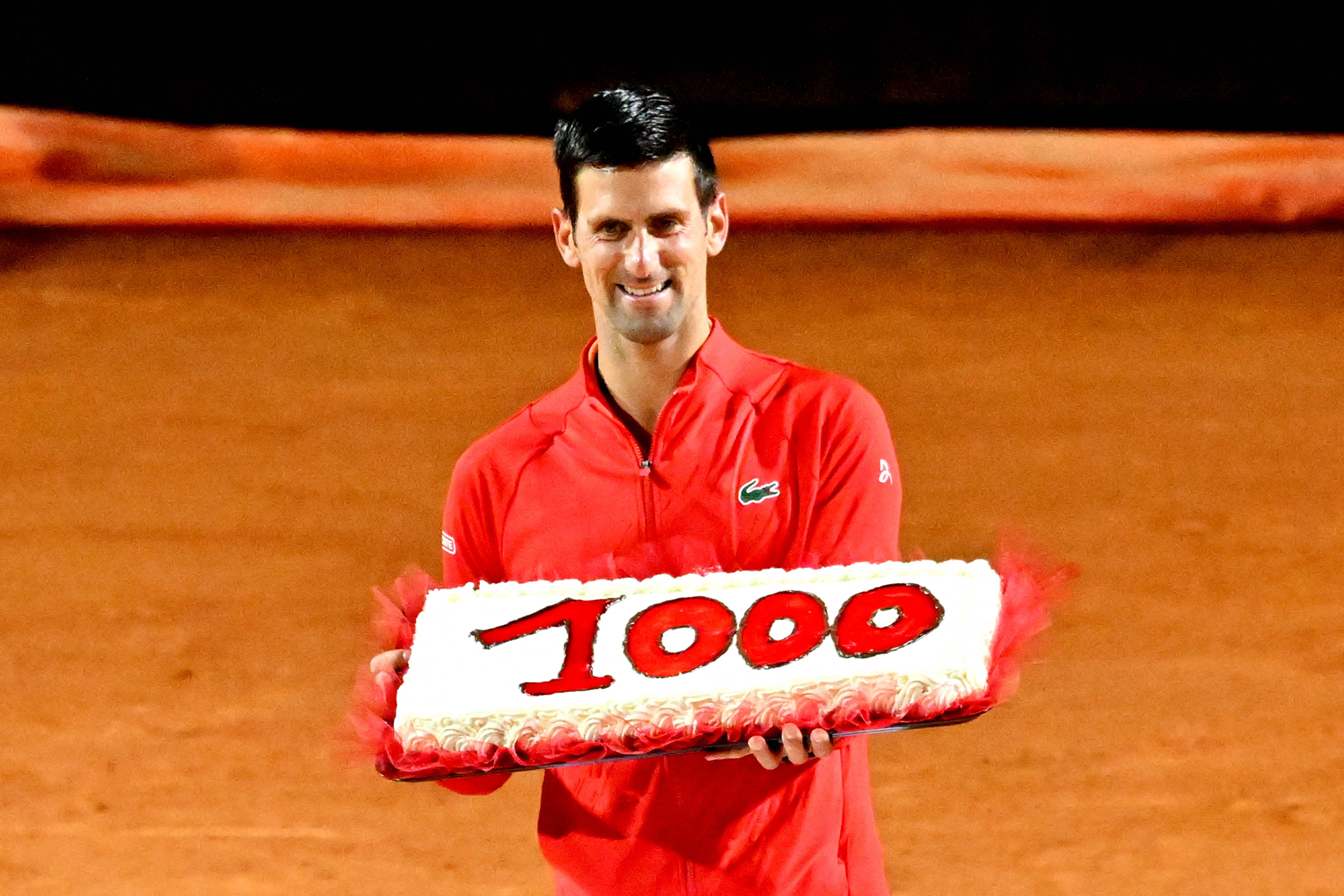 Serbia's Novak Djokovic holds a cake marking his record of 1,000 match wins on the ATP Tour. Credit: AFP Photo