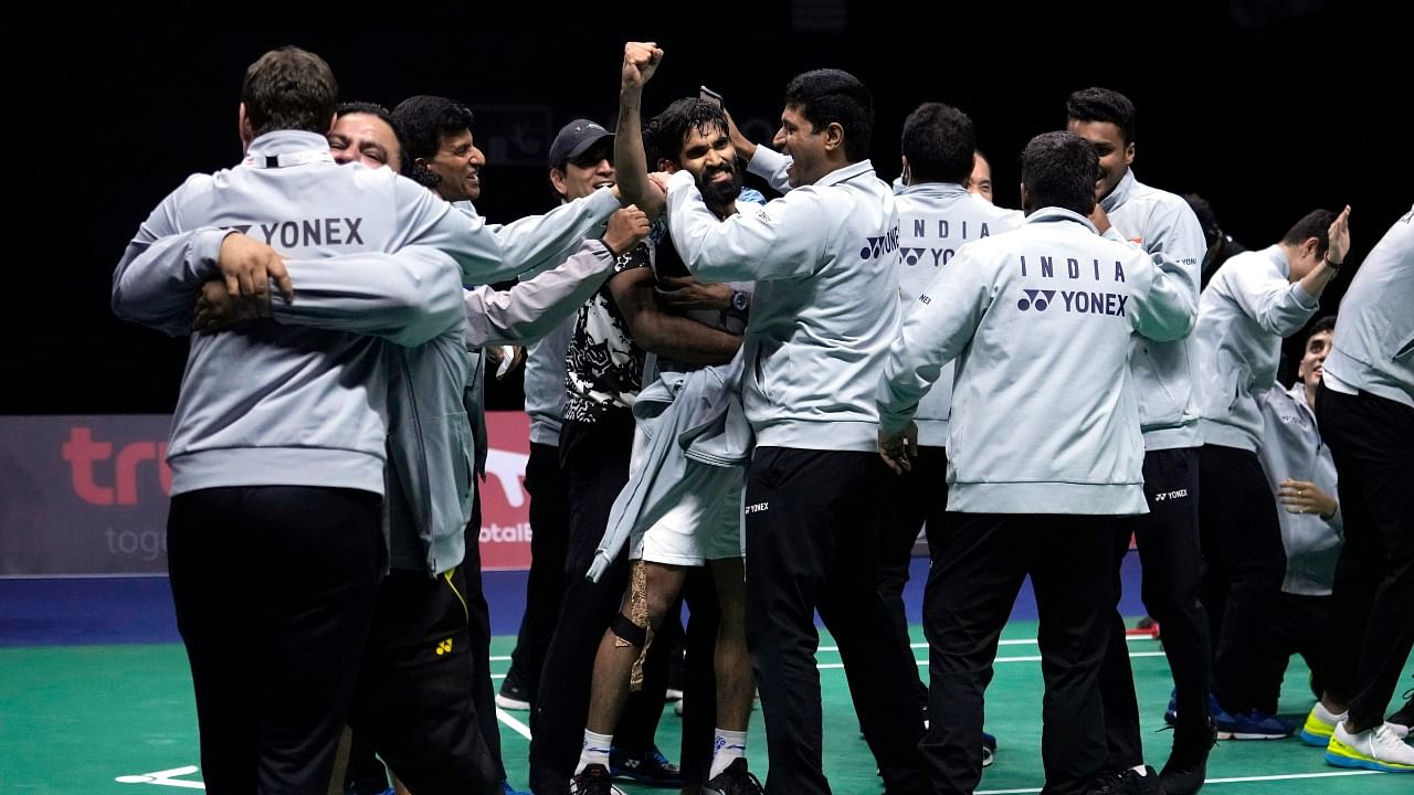 India's Kidambi Srikanth (C) and his teammates celebrate after winning a point against Indonesia's Jonatan Christie during their men's singles final badminton match at Thomas & Uber Cup in Bangkok, Thailand. Credit: AP/PTI Photo