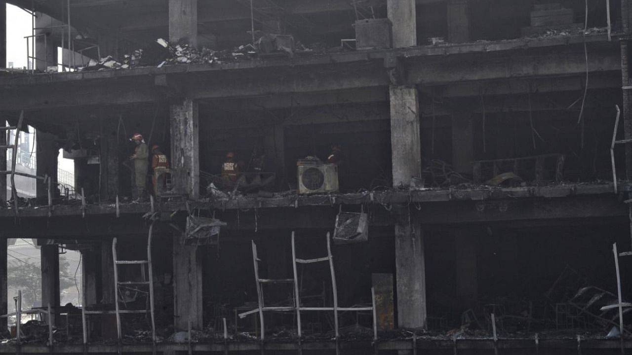 NDRF personnel during rescue and relief work after a massive fire breaks out at an office building near the Mundka Metro Station, in New Delhi. Credit: IANS photo