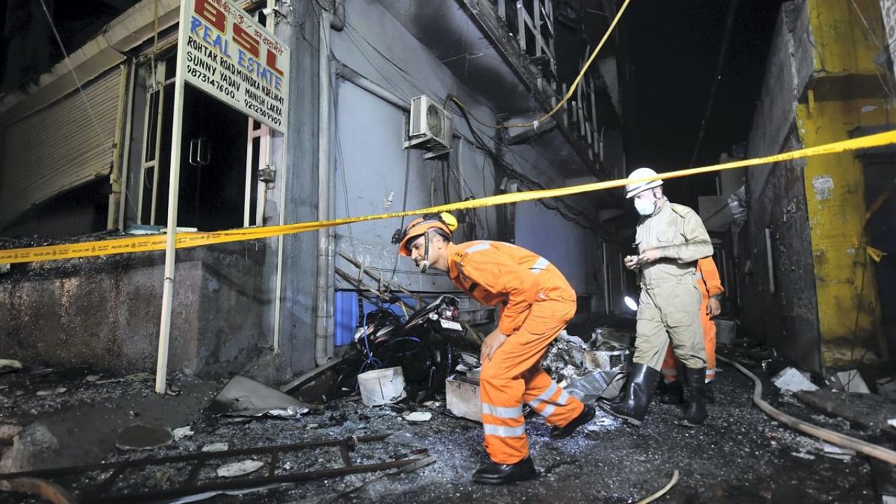 NDRF and Fire Brigade personnel carry out rescue work after a massive fire at an office building near the Mundka Metro Station, Delhi on May 14. Credit: PTI File Photo