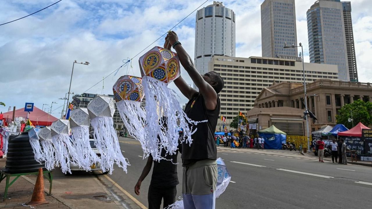 Anti-government demonstrators decorate a street near the President's office during the Vesak festival in Colombo. Credit: AFP Photo
