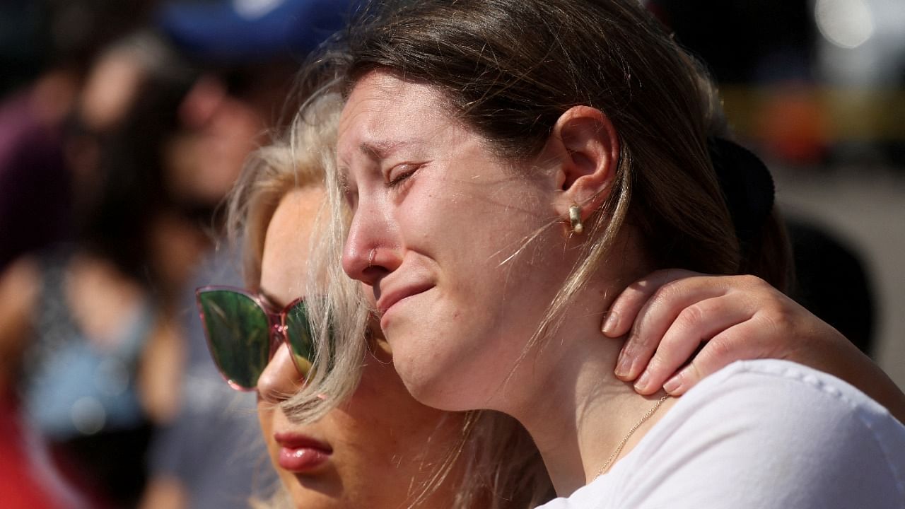 Mourners react while attending a vigil for victims of the shooting at a TOPS supermarket in Buffalo, New York. Credit: Reuters Photo
