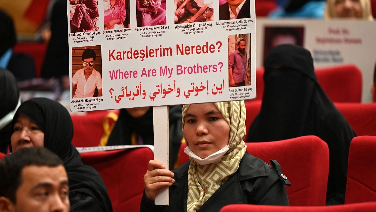 Members of Muslim Uyghur minority present pictures of their relatives detained in China during a press conference in Istanbul. Credit: AFP File Photo