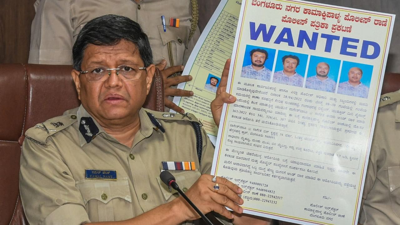 Bengaluru police chief Kamal Pant shows a poster on alleged acid attacker Nagesh Babu on Saturday. Credit: DH Photo/S K Dinesh