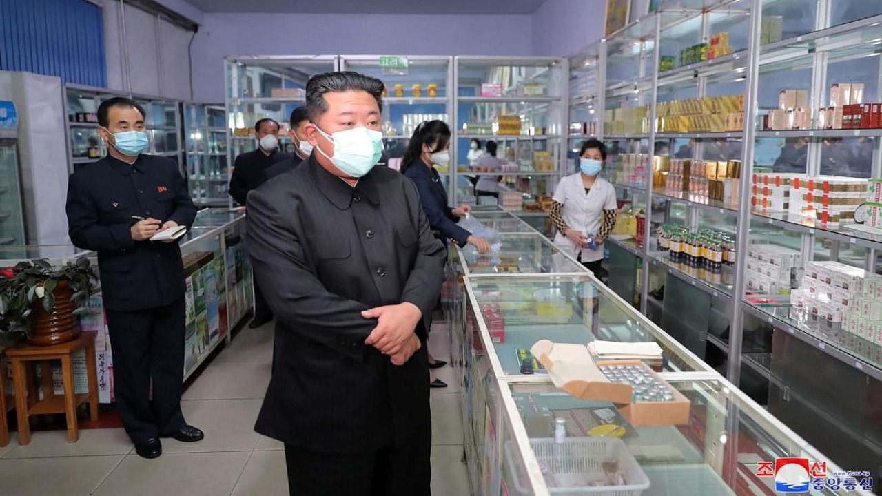 This picture taken on May 15, 2022 and released from North Korea's official Korean Central News Agency (KCNA) on May 16 shows North Korean leader Kim Jong Un (C) inspecting a pharmacy in Pyongyang. Credit: AFP Photo