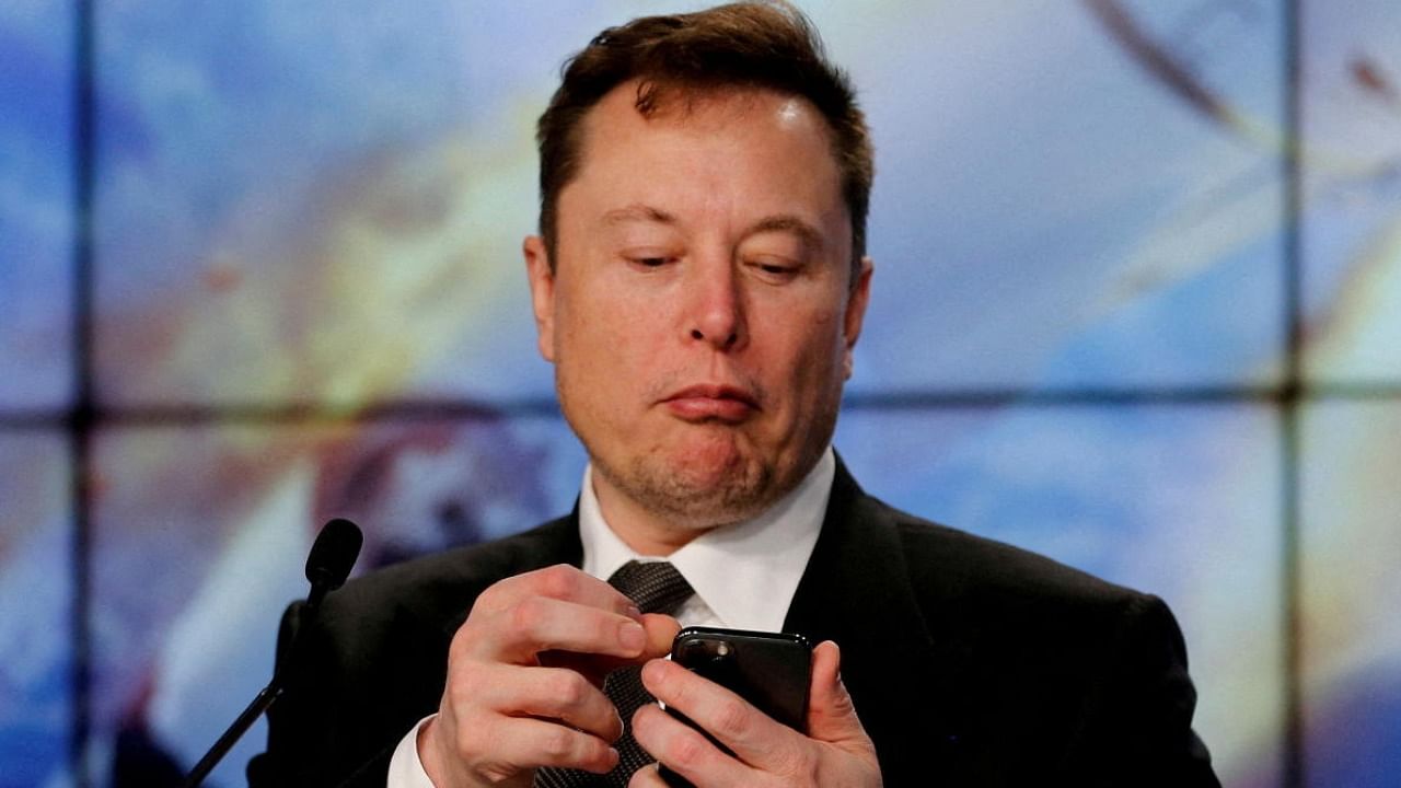 Elon Musk looks at his mobile phone in Cape Canaveral. Credit: Reuters Photo