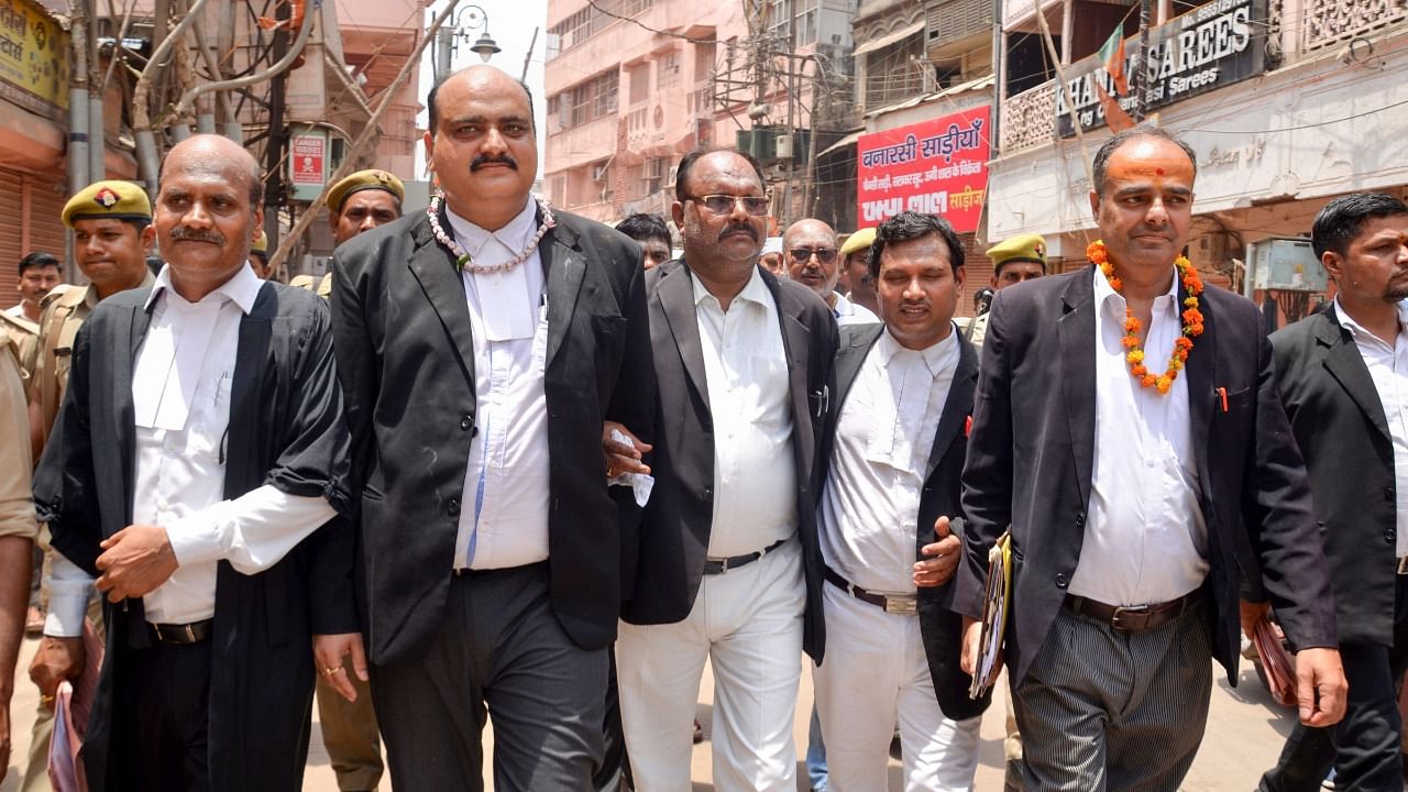 Court Commissioners with their team leave after the third and last day of a videographic survey at Gyanvapi Mosque complex. Credit: PTI Photo