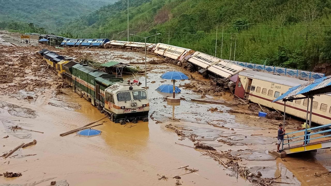In this photograph train carriages are seen toppled over following a landslide caused by a heavy rainfall at New Haflong railway station on the Lumding-Silchar route at Dima Hasao district, Assam. Credit: AFP File Photo