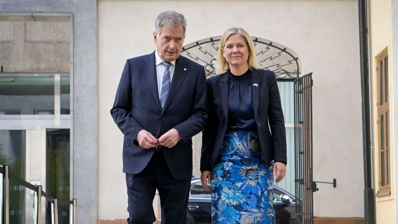Finland's President Sauli Niinisto (L) walks with Sweden's Prime Minister Magdalena Andersson. Credit: AFP Photo